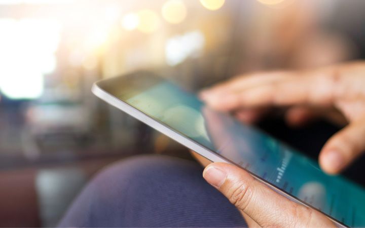 Hands holding a tablet, researching